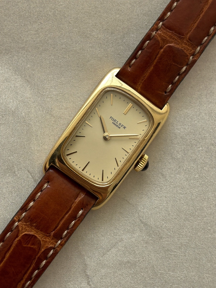 Gold vintage wristwatch with cream dial and leather strap